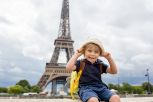 young tourist boy in front of the Eiffel Tower landmark