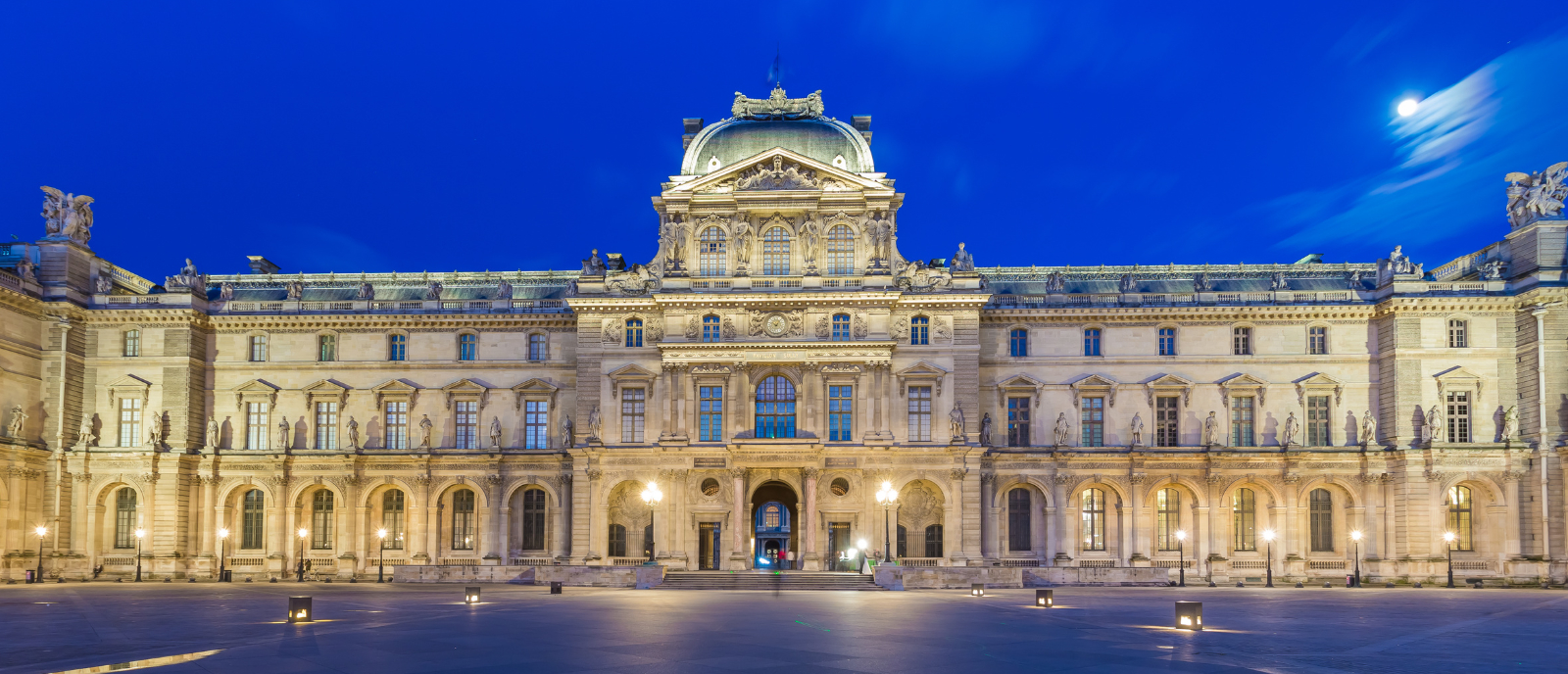 Cour Carrée du Louvre at Night - Adobe Stock Night view of the Cour Carrée at the Louvre in Paris, showing the illuminated classical façade under a deep blue sky