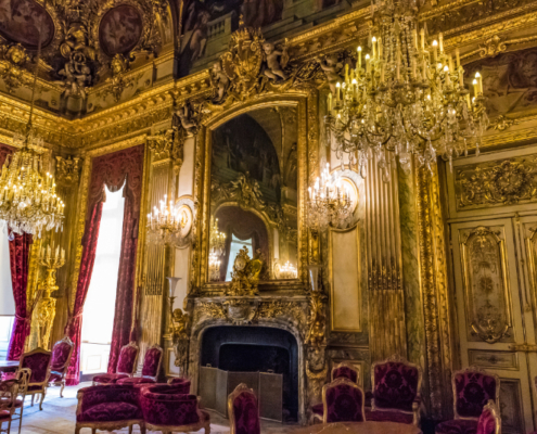 View of the Apartments of Napoleon III at the Louvre. Source: Adobe Stock Interior view of the Apartments of Napoleon III at the Louvre in Paris, showing gilded walls, crystal chandeliers, velvet seating, and richly decorated Second Empire interiors