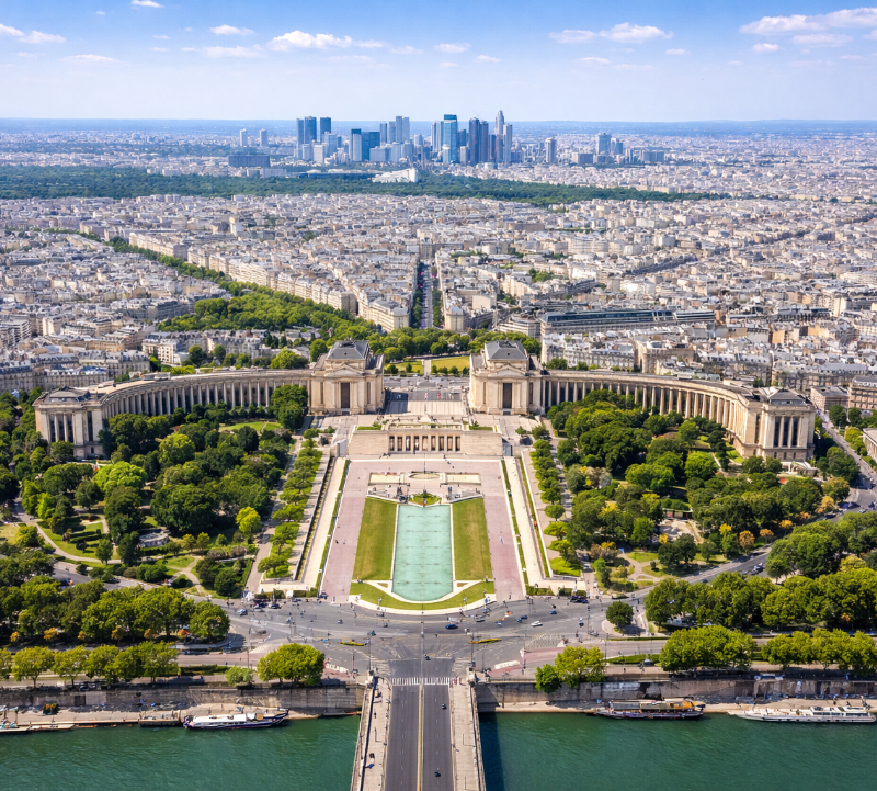 AI-generated daytime aerial view of the Trocadéro Gardens, Palais de Chaillot, the Seine, and Paris skyline with La Défense in the distance