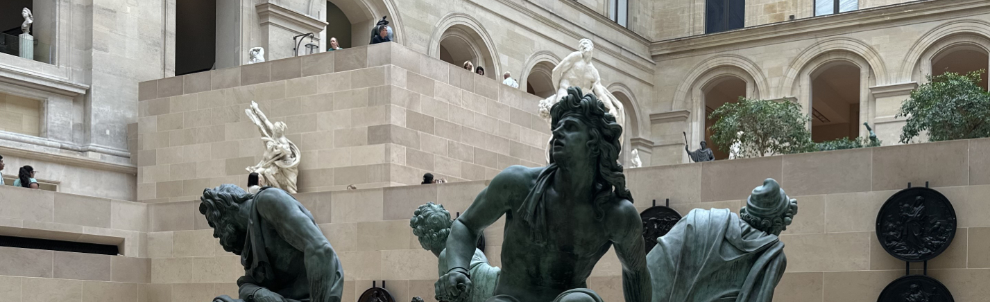 Bronze Sculpture in the Cour Marly2 View of a monumental bronze sculpture displayed in the Cour Marly at the Louvre, with pale stone façades, arcades, and surrounding sculptures in the skylit courtyard.