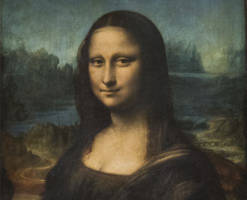 Adobe Stock view of the Mona Lisa at the Louvre. View of the Mona Lisa displayed in its ornate gilded frame at the Louvre, showing Leonardo da Vinci’s portrait against a dark landscape background.